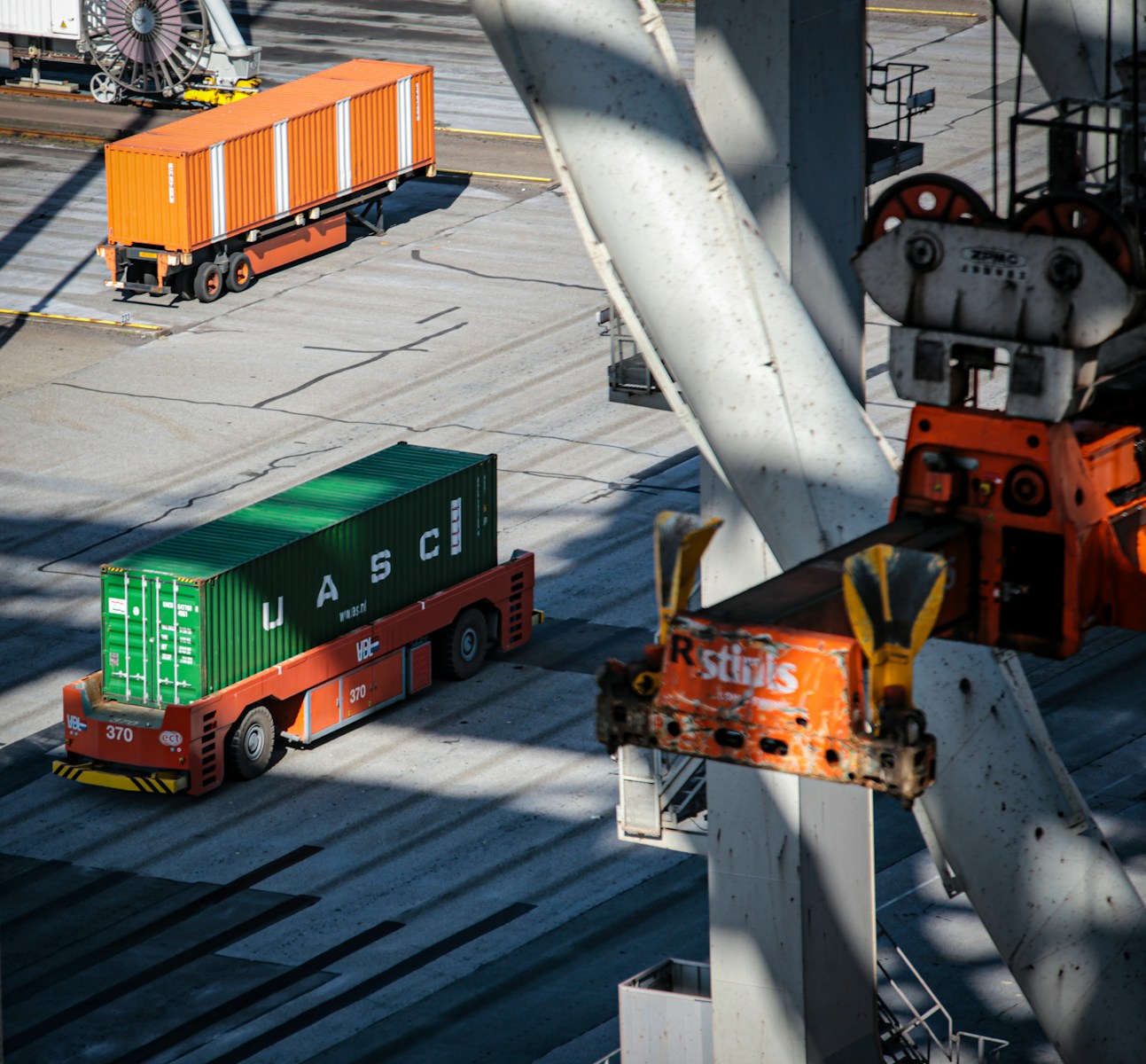 a cargo truck driving down a road next to a loading dock